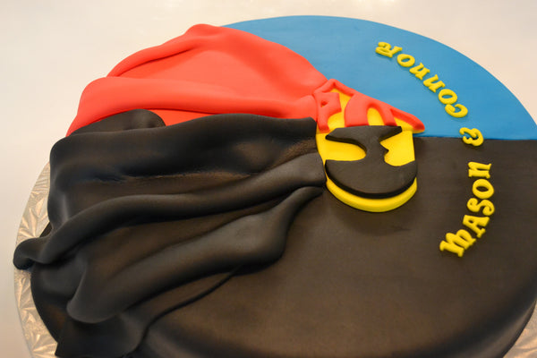 Batman & Superman cake by Sugar Street Boutique. Toronto cake. Lemon cake. lemon superhero cake. batman cake. superman cake. superhero cake. fondant cake. toronto baker. sugar street boutique. superheroes. superheroes cake. cape cake. superman. batman.