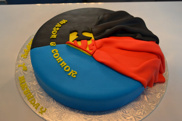 Batman & Superman cake by Sugar Street Boutique. Toronto cake. Lemon cake. lemon superhero cake. batman cake. superman cake. superhero cake. fondant cake. toronto baker. sugar street boutique. superheroes. superheroes cake. cape cake. superman. batman.