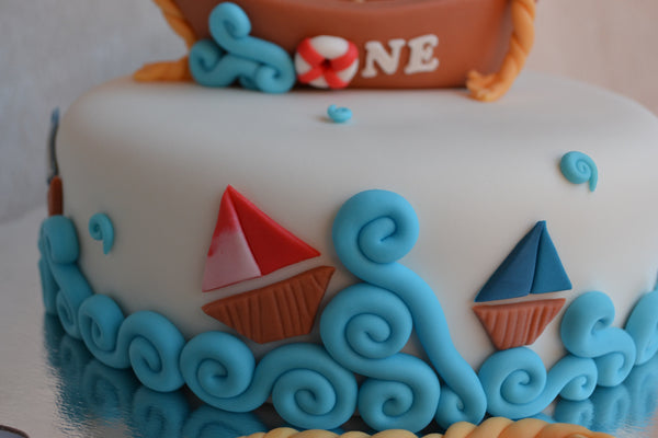 Boat cake by Sugar Street Boutique. Toronto cakes. Chocolate cake. Fondant cake. Boat sweet. Boat cake. sailor cake. one birthday cake.  fondant boat. fondant sailor. boat cake toronto. sugar street boutique. designer cake. boat.