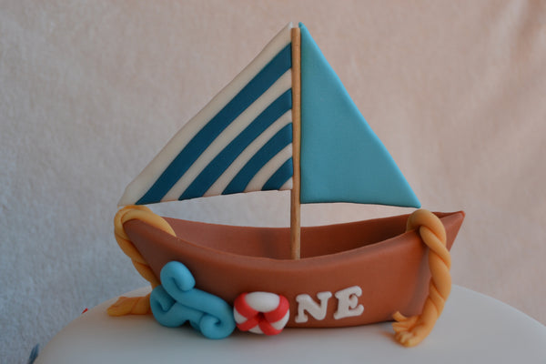 Boat cake by Sugar Street Boutique. Toronto cakes. Chocolate cake. Fondant cake. Boat sweet. Boat cake. sailor cake. one birthday cake.  fondant boat. fondant sailor. boat cake toronto. sugar street boutique. designer cake. boat.