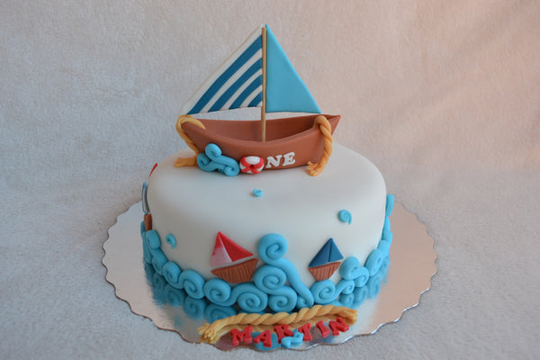 Boat cake by Sugar Street Boutique. Toronto cakes. Chocolate cake. Fondant cake. Boat sweet. Boat cake. sailor cake. one birthday cake.  fondant boat. fondant sailor. boat cake toronto. sugar street boutique. designer cake. boat.