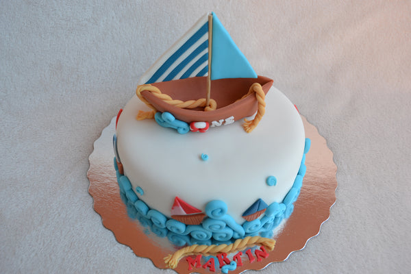 Boat cake by Sugar Street Boutique. Toronto cakes. Chocolate cake. Fondant cake. Boat sweet. Boat cake. sailor cake. one birthday cake.  fondant boat. fondant sailor. boat cake toronto. sugar street boutique. designer cake. boat.