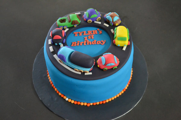 Cars & Trucks cake by Sugar Street Boutique Toronto. toronto cakes. cars cake. cars cake toronto. truck cake. truck cake toronto. cars and trucks cake. cars and trucks cake toronto. fondant cars. blue cake. vanilla fondant cake. cars and trucks. 1st birthday cake. first birthday cake. designer cake.sugar street boutique. cars and truck party.  cars party. trucks party. birthday cars. birthday cars cake.