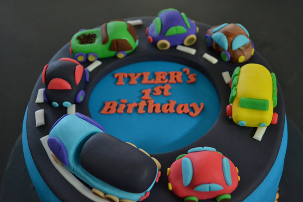 Cars & Trucks cake by Sugar Street Boutique Toronto. toronto cakes. cars cake. cars cake toronto. truck cake. truck cake toronto. cars and trucks cake. cars and trucks cake toronto. fondant cars. blue cake. vanilla fondant cake. cars and trucks. 1st birthday cake. first birthday cake. designer cake.sugar street boutique. cars and truck party.  cars party. trucks party. birthday cars. birthday cars cake.