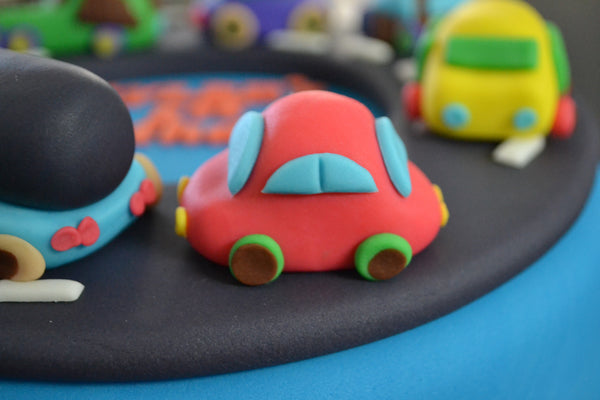 Cars & Trucks cake by Sugar Street Boutique Toronto. toronto cakes. cars cake. cars cake toronto. truck cake. truck cake toronto. cars and trucks cake. cars and trucks cake toronto. fondant cars. blue cake. vanilla fondant cake. cars and trucks. 1st birthday cake. first birthday cake. designer cake.sugar street boutique. cars and truck party.  cars party. trucks party. birthday cars. birthday cars cake.