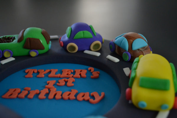 Cars & Trucks cake by Sugar Street Boutique Toronto. toronto cakes. cars cake. cars cake toronto. truck cake. truck cake toronto. cars and trucks cake. cars and trucks cake toronto. fondant cars. blue cake. vanilla fondant cake. cars and trucks. 1st birthday cake. first birthday cake. designer cake.sugar street boutique. cars and truck party.  cars party. trucks party. birthday cars. birthday cars cake.