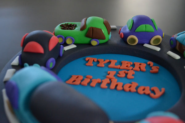 Cars & Trucks cake by Sugar Street Boutique Toronto. toronto cakes. cars cake. cars cake toronto. truck cake. truck cake toronto. cars and trucks cake. cars and trucks cake toronto. fondant cars. blue cake. vanilla fondant cake. cars and trucks. 1st birthday cake. first birthday cake. designer cake.sugar street boutique. cars and truck party.  cars party. trucks party. birthday cars. birthday cars cake.