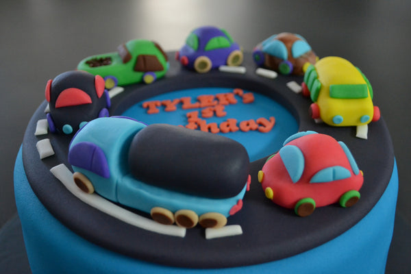 Cars & Trucks cake by Sugar Street Boutique Toronto. toronto cakes. cars cake. cars cake toronto. truck cake. truck cake toronto. cars and trucks cake. cars and trucks cake toronto. fondant cars. blue cake. vanilla fondant cake. cars and trucks. 1st birthday cake. first birthday cake. designer cake.sugar street boutique. cars and truck party.  cars party. trucks party. birthday cars. birthday cars cake.