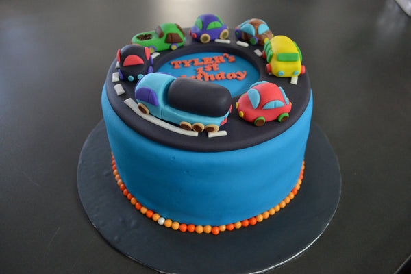 Cars & Trucks cake by Sugar Street Boutique Toronto. toronto cakes. cars cake. cars cake toronto. truck cake. truck cake toronto. cars and trucks cake. cars and trucks cake toronto. fondant cars. blue cake. vanilla fondant cake. cars and trucks. 1st birthday cake. first birthday cake. designer cake.sugar street boutique. cars and truck party.  cars party. trucks party. birthday cars. birthday cars cake.
