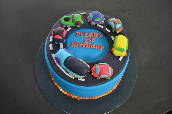 Cars & Trucks cake by Sugar Street Boutique Toronto. toronto cakes. cars cake. cars cake toronto. truck cake. truck cake toronto. cars and trucks cake. cars and trucks cake toronto. fondant cars. blue cake. vanilla fondant cake. cars and trucks. 1st birthday cake. first birthday cake. designer cake.sugar street boutique. cars and truck party.  cars party. trucks party. birthday cars. birthday cars cake.