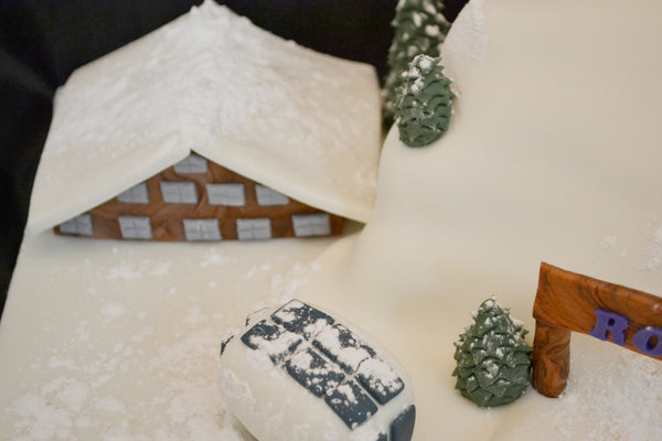 ski cake by Sugar Street Boutique. Sugar Street Boutique Toronto. Ski cake. snow cake. slope ski cake. skier cake. gondola cake. cabin cake. slope cake. red velvet cake. designer cake. ski cake toronto. 