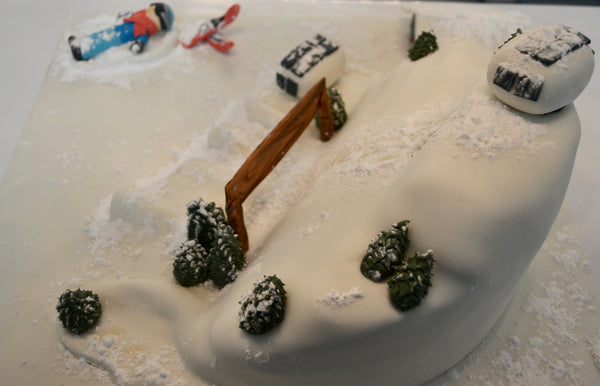 ski cake by Sugar Street Boutique. Sugar Street Boutique Toronto. Ski cake. snow cake. slope ski cake. skier cake. gondola cake. cabin cake. slope cake. red velvet cake. designer cake. ski cake toronto. 