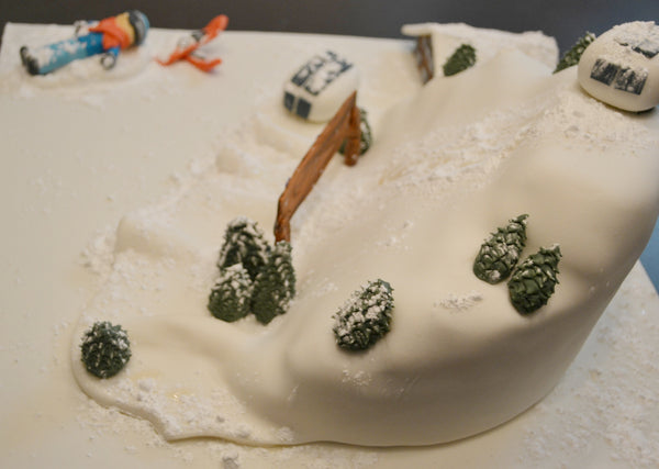ski cake by Sugar Street Boutique. Sugar Street Boutique Toronto. Ski cake. snow cake. slope ski cake. skier cake. gondola cake. cabin cake. slope cake. red velvet cake. designer cake. ski cake toronto. 