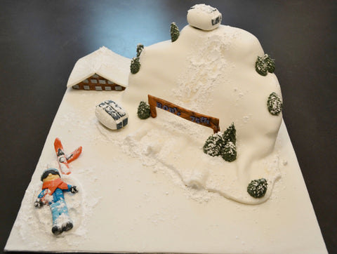 ski cake by Sugar Street Boutique. Sugar Street Boutique Toronto. Ski cake. snow cake. slope ski cake. skier cake. gondola cake. cabin cake. slope cake. red velvet cake. designer cake. ski cake toronto. 
