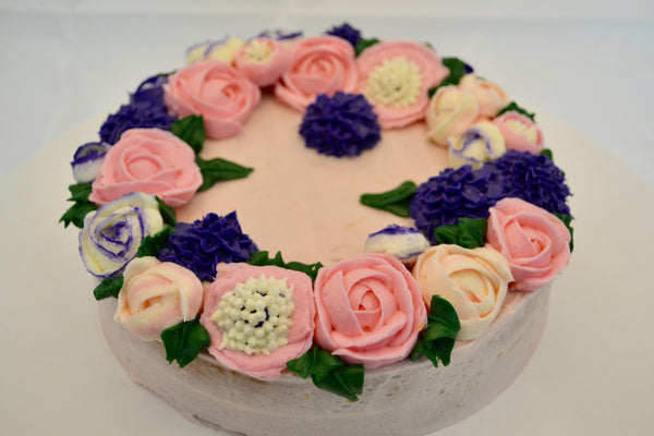 icing flower cake by sugar street boutique. sugar street boutique. icing flower cake. icing flower cake toronto. toronto cakes. lemon cake. lemon curd filling. lemon cream cheese icing. lemon flowers. cream cheese flowers. flowers cake. flowers cake toronto. designer cake. purple flowers cake.  colourful flower cake. light pink flowers icing. pink and purple icing flowers. piping flowers.  icing flowers cake toronto.
