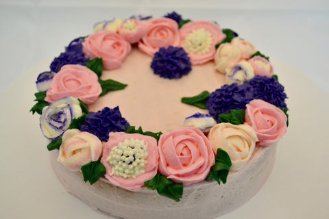 icing flower cake by sugar street boutique. sugar street boutique. icing flower cake. icing flower cake toronto. toronto cakes. lemon cake. lemon curd filling. lemon cream cheese icing. lemon flowers. cream cheese flowers. flowers cake. flowers cake toronto. designer cake. purple flowers cake.  colourful flower cake. light pink flowers icing. pink and purple icing flowers. piping flowers.  icing flowers cake toronto.
