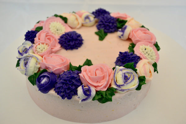 icing flower cake by sugar street boutique. sugar street boutique. icing flower cake. icing flower cake toronto. toronto cakes. lemon cake. lemon curd filling. lemon cream cheese icing. lemon flowers. cream cheese flowers. flowers cake. flowers cake toronto. designer cake. purple flowers cake.  colourful flower cake. light pink flowers icing. pink and purple icing flowers. piping flowers.  icing flowers cake toronto.