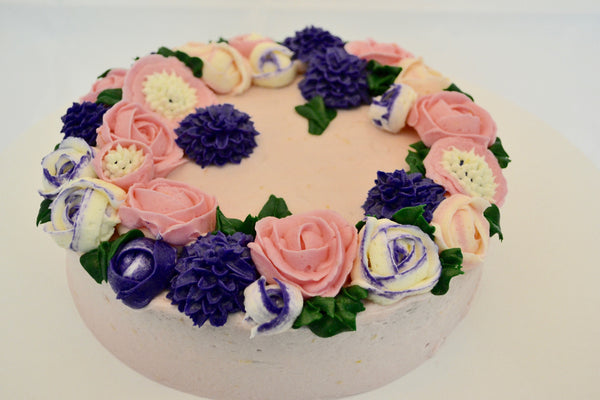 icing flower cake by sugar street boutique. sugar street boutique. icing flower cake. icing flower cake toronto. toronto cakes. lemon cake. lemon curd filling. lemon cream cheese icing. lemon flowers. cream cheese flowers. flowers cake. flowers cake toronto. designer cake. purple flowers cake.  colourful flower cake. light pink flowers icing. pink and purple icing flowers. piping flowers.  icing flowers cake toronto.