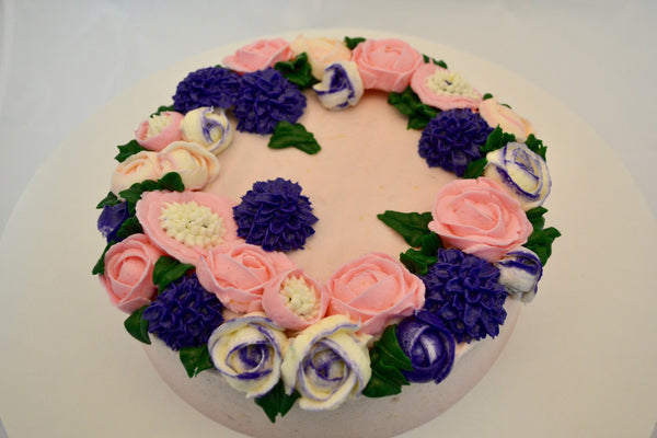 icing flower cake by sugar street boutique. sugar street boutique. icing flower cake. icing flower cake toronto. toronto cakes. lemon cake. lemon curd filling. lemon cream cheese icing. lemon flowers. cream cheese flowers. flowers cake. flowers cake toronto. designer cake. purple flowers cake.  colourful flower cake. light pink flowers icing. pink and purple icing flowers. piping flowers.  icing flowers cake toronto.
