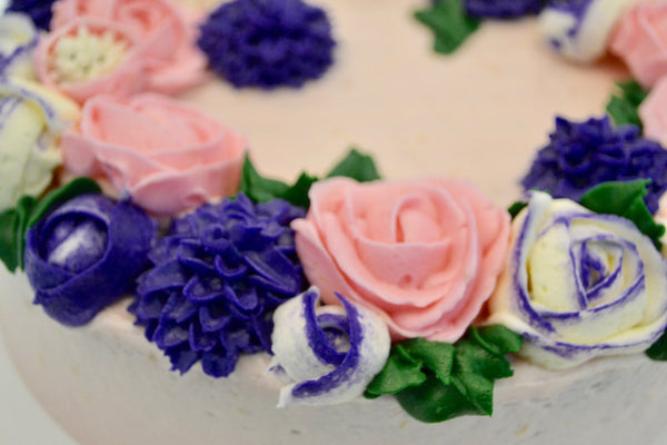 icing flower cake by sugar street boutique. sugar street boutique. icing flower cake. icing flower cake toronto. toronto cakes. lemon cake. lemon curd filling. lemon cream cheese icing. lemon flowers. cream cheese flowers. flowers cake. flowers cake toronto. designer cake. purple flowers cake.  colourful flower cake. light pink flowers icing. pink and purple icing flowers. piping flowers.  icing flowers cake toronto.