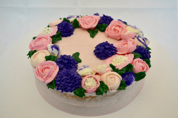 icing flower cake by sugar street boutique. sugar street boutique. icing flower cake. icing flower cake toronto. toronto cakes. lemon cake. lemon curd filling. lemon cream cheese icing. lemon flowers. cream cheese flowers. flowers cake. flowers cake toronto. designer cake. purple flowers cake.  colourful flower cake. light pink flowers icing. pink and purple icing flowers. piping flowers.  icing flowers cake toronto.