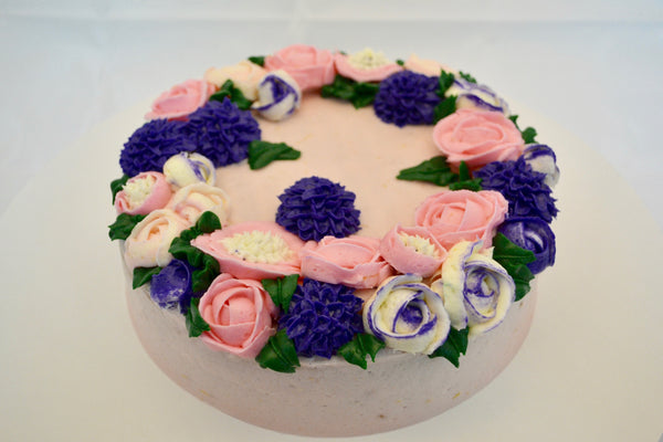icing flower cake by sugar street boutique. sugar street boutique. icing flower cake. icing flower cake toronto. toronto cakes. lemon cake. lemon curd filling. lemon cream cheese icing. lemon flowers. cream cheese flowers. flowers cake. flowers cake toronto. designer cake. purple flowers cake.  colourful flower cake. light pink flowers icing. pink and purple icing flowers. piping flowers.  icing flowers cake toronto.