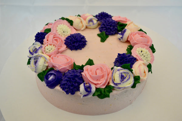 icing flower cake by sugar street boutique. sugar street boutique. icing flower cake. icing flower cake toronto. toronto cakes. lemon cake. lemon curd filling. lemon cream cheese icing. lemon flowers. cream cheese flowers. flowers cake. flowers cake toronto. designer cake. purple flowers cake.  colourful flower cake. light pink flowers icing. pink and purple icing flowers. piping flowers.  icing flowers cake toronto.