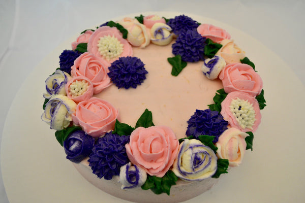 icing flower cake by sugar street boutique. sugar street boutique. icing flower cake. icing flower cake toronto. toronto cakes. lemon cake. lemon curd filling. lemon cream cheese icing. lemon flowers. cream cheese flowers. flowers cake. flowers cake toronto. designer cake. purple flowers cake.  colourful flower cake. light pink flowers icing. pink and purple icing flowers. piping flowers.  icing flowers cake toronto.