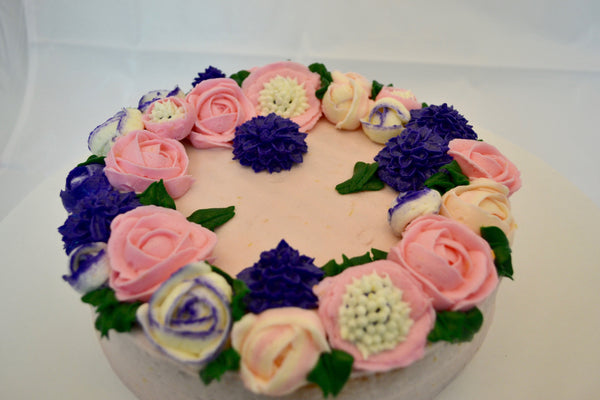 icing flower cake by sugar street boutique. sugar street boutique. icing flower cake. icing flower cake toronto. toronto cakes. lemon cake. lemon curd filling. lemon cream cheese icing. lemon flowers. cream cheese flowers. flowers cake. flowers cake toronto. designer cake. purple flowers cake.  colourful flower cake. light pink flowers icing. pink and purple icing flowers. piping flowers.  icing flowers cake toronto.