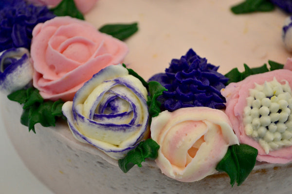 icing flower cake by sugar street boutique. sugar street boutique. icing flower cake. icing flower cake toronto. toronto cakes. lemon cake. lemon curd filling. lemon cream cheese icing. lemon flowers. cream cheese flowers. flowers cake. flowers cake toronto. designer cake. purple flowers cake.  colourful flower cake. light pink flowers icing. pink and purple icing flowers. piping flowers.  icing flowers cake toronto.