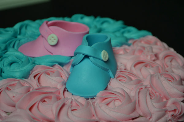 Vanilla Gender reveal baby cake with pink and blue rosettes and pink or blue smarties in the centre to reveal the gender of the baby by Sugar Street Boutique Toronto.