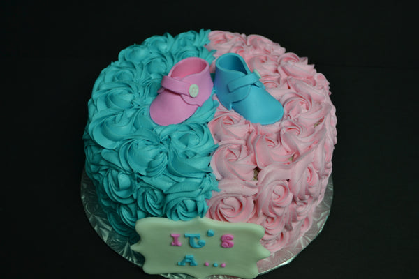 Vanilla Gender reveal baby cake with pink and blue rosettes and pink or blue smarties in the centre to reveal the gender of the baby by Sugar Street Boutique Toronto.