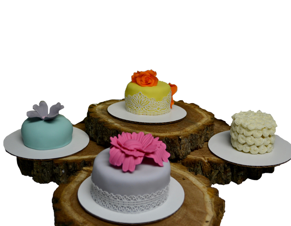 Mini cakes, individually sized, red velvet mini cake, chocolate mini cake, lemon mini cake and vanilla mini cake decorated with edible flowers, small icing rosettes with spring colours by Sugar Street Boutique