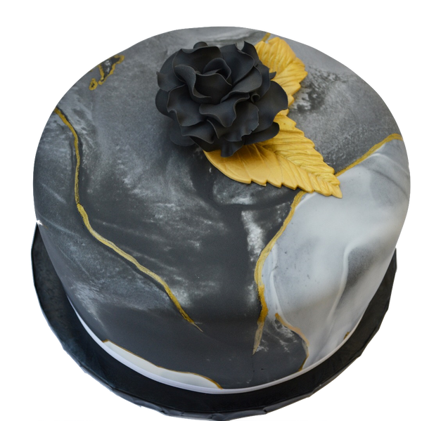Black marble lemon cake with gold accents and an edible black rose, filled with lemon curd and a light lemon icing in between layers. Sugar Street Boutique toronto cakes.