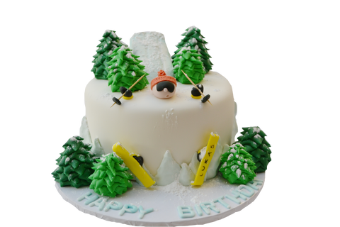 skiing cake made with chocolate and fondant snow skiing man barried in snow with edible trees and ski slope by sugar street boutique toronto cakes