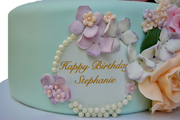 soft teal chocolate cake covered in fondant with edible flowers for a birthday by Sugar Street Boutique Toronto