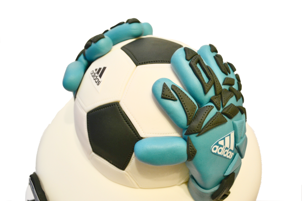 Soccer Keeper Chocolate cake by sugar street boutique Toronto cakes. Soccer ball cake with keeper gloves.