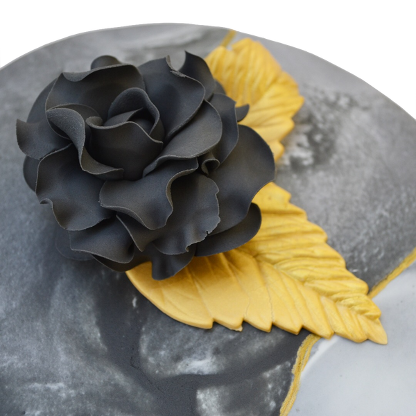 Black marble lemon cake with gold accents and an edible black rose, filled with lemon curd and a light lemon icing in between layers. Sugar Street Boutique toronto cakes.
