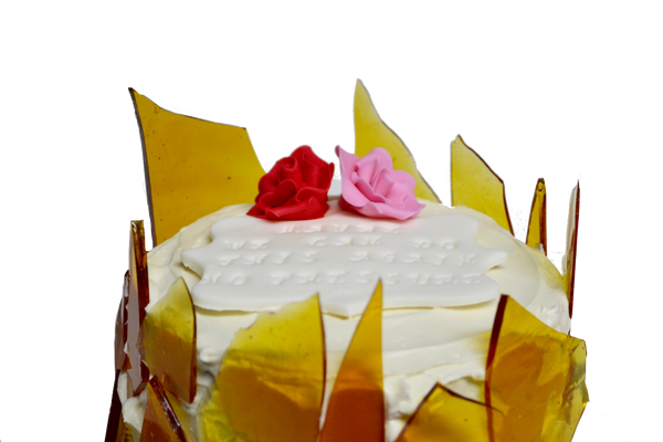 creme brûlée cake with sugar shards and edible pink and red roses with personalized note for valentines day by sugar street boutique, toronto.