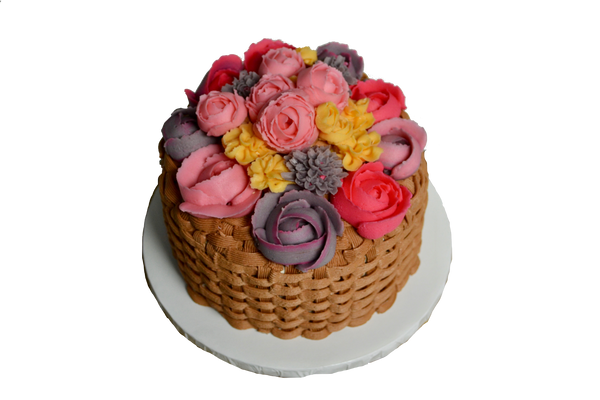 Carrot cake with cream cheese icing decorated with yellow, pink, grey flowers and roses and basket icing by Sugar Street Boutique Toronto