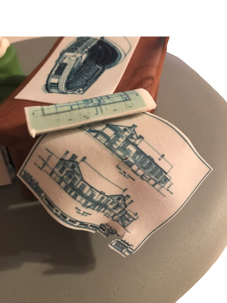 Arquitect cake featuring the Toronto Skydome/Rogers centre, an edible wooden table, edible blue prints, burger, hot sauce and an architects scale by Sugar Street Boutique Toronto