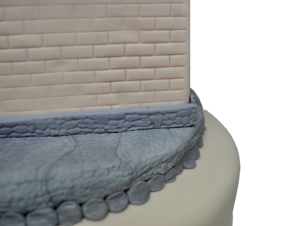 castle cake made of vanilla and fondant decorated with fondant rocks, fondant bricks, fondant castle perfect for a queen castle or king castle by sugar street boutique toronto