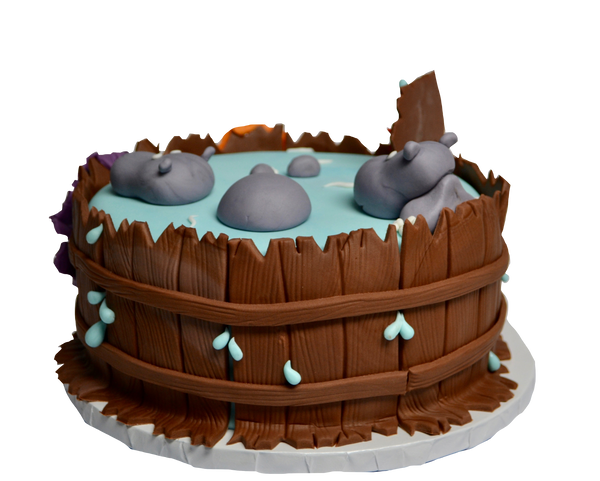 Hippos in a hot tub cake with clothes hanging over the tub decorated with fondant and water spilling over the tub by sugar street boutique toronto