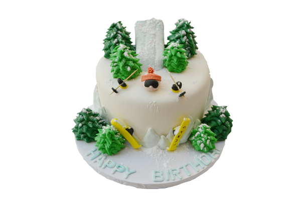 skiing cake made with chocolate and fondant snow skiing man barried in snow with edible trees and ski slope by sugar street boutique toronto cakes