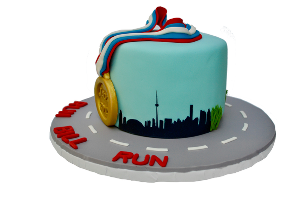 jazz run toronto marathon 2017 cake with a gold medal, the toronto skyline and a running man, run bill run. Vanilla cake with chocolate icing by sugar street boutique toronto.