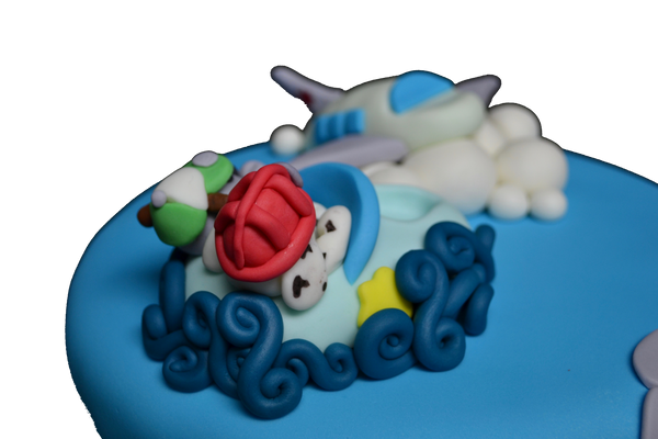 A fully loaded cake with a plane, boat and a train with Marshall & Rocky from Paw Patrol by sugar street boutique