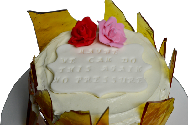 creme brûlée cake with sugar shards and edible pink and red roses with personalized note for valentines day by sugar street boutique, toronto.