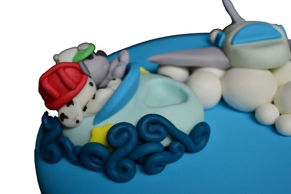 A fully loaded cake with a plane, boat and a train with Marshall & Rocky from Paw Patrol by sugar street boutique