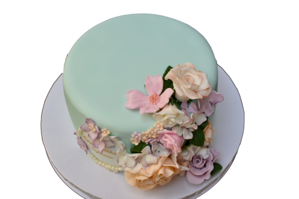 soft teal chocolate cake covered in fondant with edible flowers for a birthday by Sugar Street Boutique Toronto