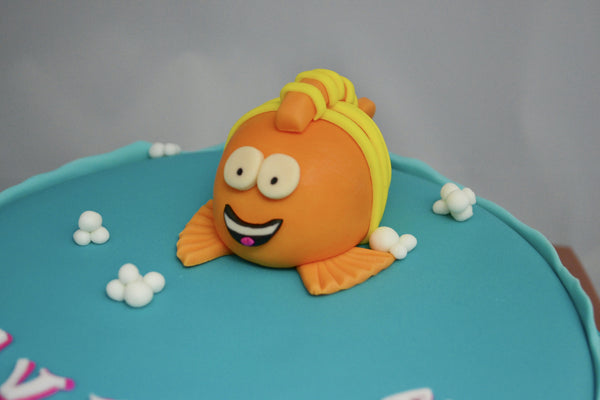 Bubble Guppies character Mr. Grouper chocolate cake covered with fondant and edible figurines by Sugar Street Boutique Toronto made for a birthday.